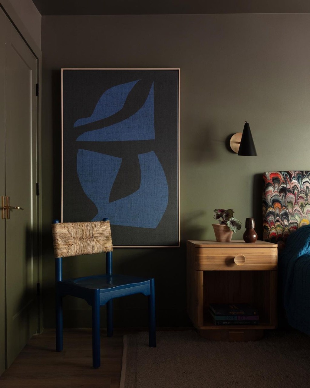 Dormitor cu pereti de culoare verde masliniu si o piesa de arta mare